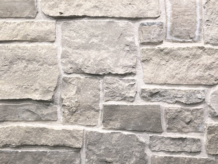 closeup of sandcastle natural stone veneer display with white mortar