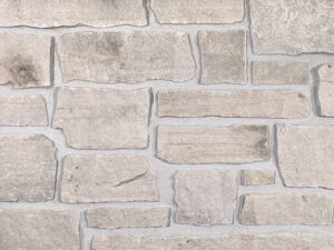 closeup of sandy creek natural stone veneer showroom display with standard grey mortar