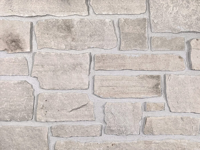 closeup of sandy creek natural stone veneer showroom display with standard grey mortar