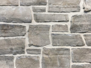 closeup of silver mist natural stone veneer display with white mortar