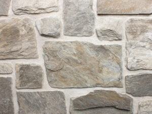 closeup of silver patina castle rock natural stone veneer display with white mortar