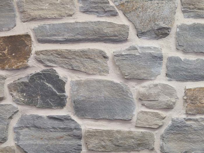 closeup of silver patina seina natural stone veneer display with white mortar