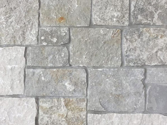 closeup of stone harbor blue vein bedface natural stone veneer display with standard gray mortar