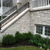 close up of the first floor of a home sided in stone harbor tumbled thin stone veneer