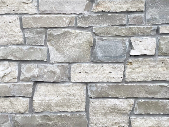 closeup of stratford cross natural stone veneer display with standard grey mortar
