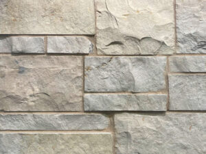 closeup of sussex buff natural stone veneer display with 50% black, 50% white mortar mix