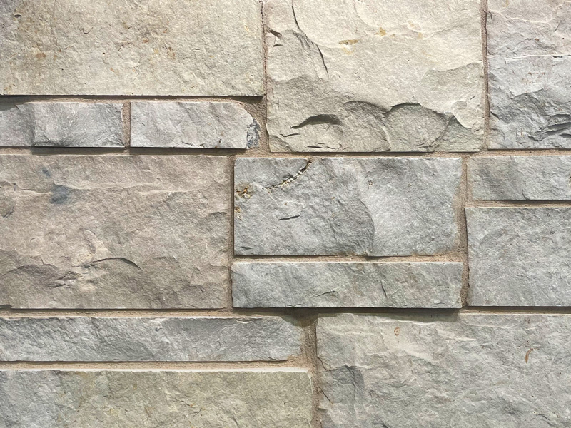 closeup of sussex buff natural stone veneer display with 50% black, 50% white mortar mix