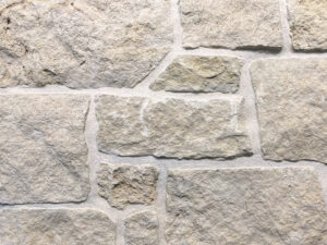 closeup of weston cream squares and recs natural stone veneer display with restoration mortar