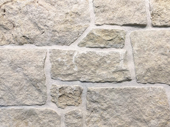 closeup of weston cream squares and recs natural stone veneer display with restoration mortar
