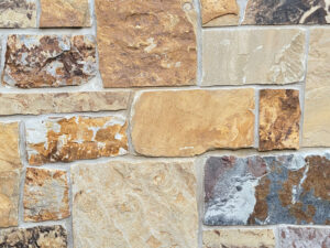 closeup of whiskey barrel pass natural stone veneer display with standard grey mortar